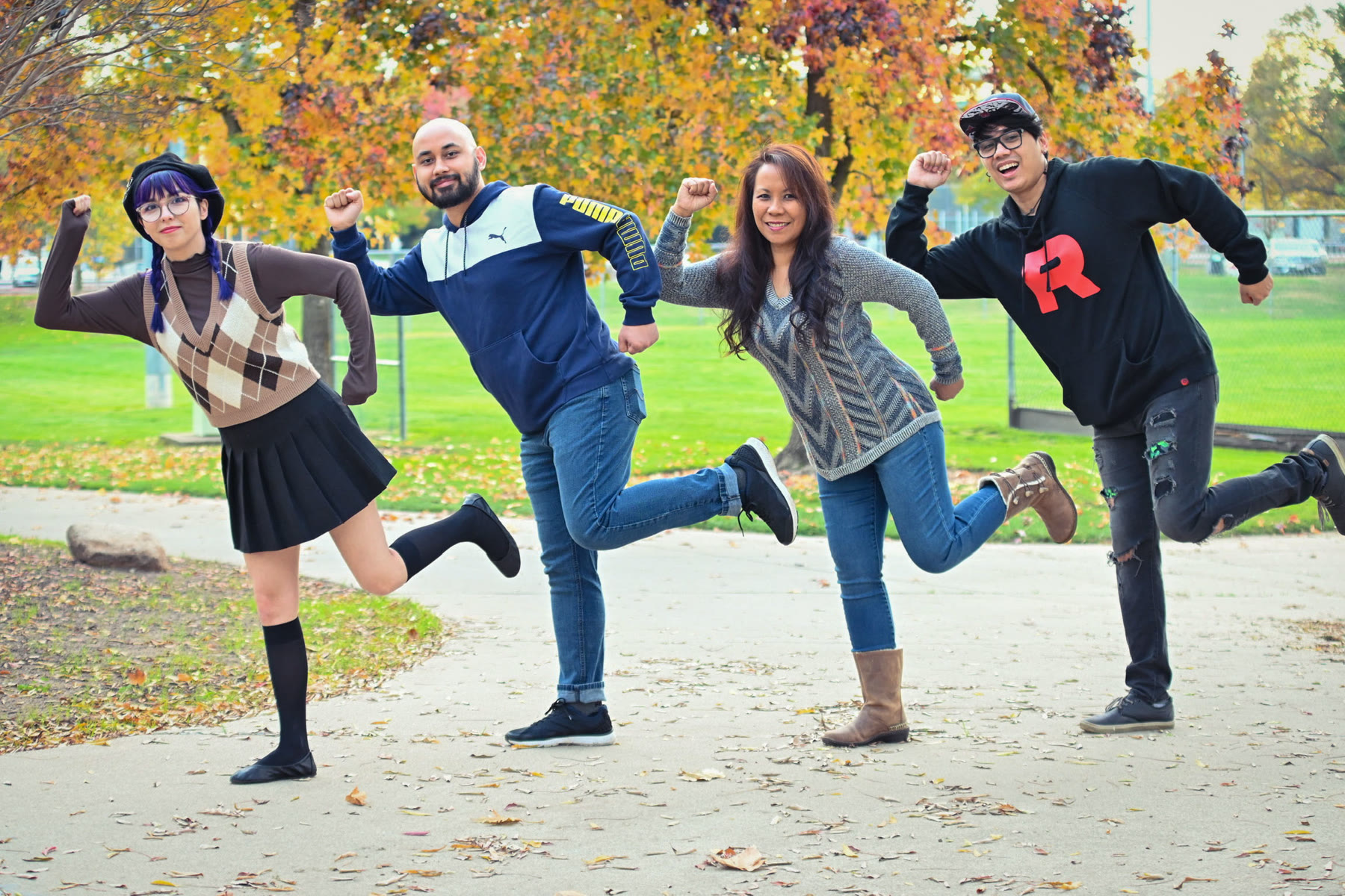 A family caught mid-jump under autumn trees