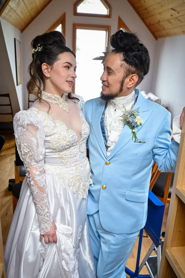 A bride and groom laughing together before the ceremony